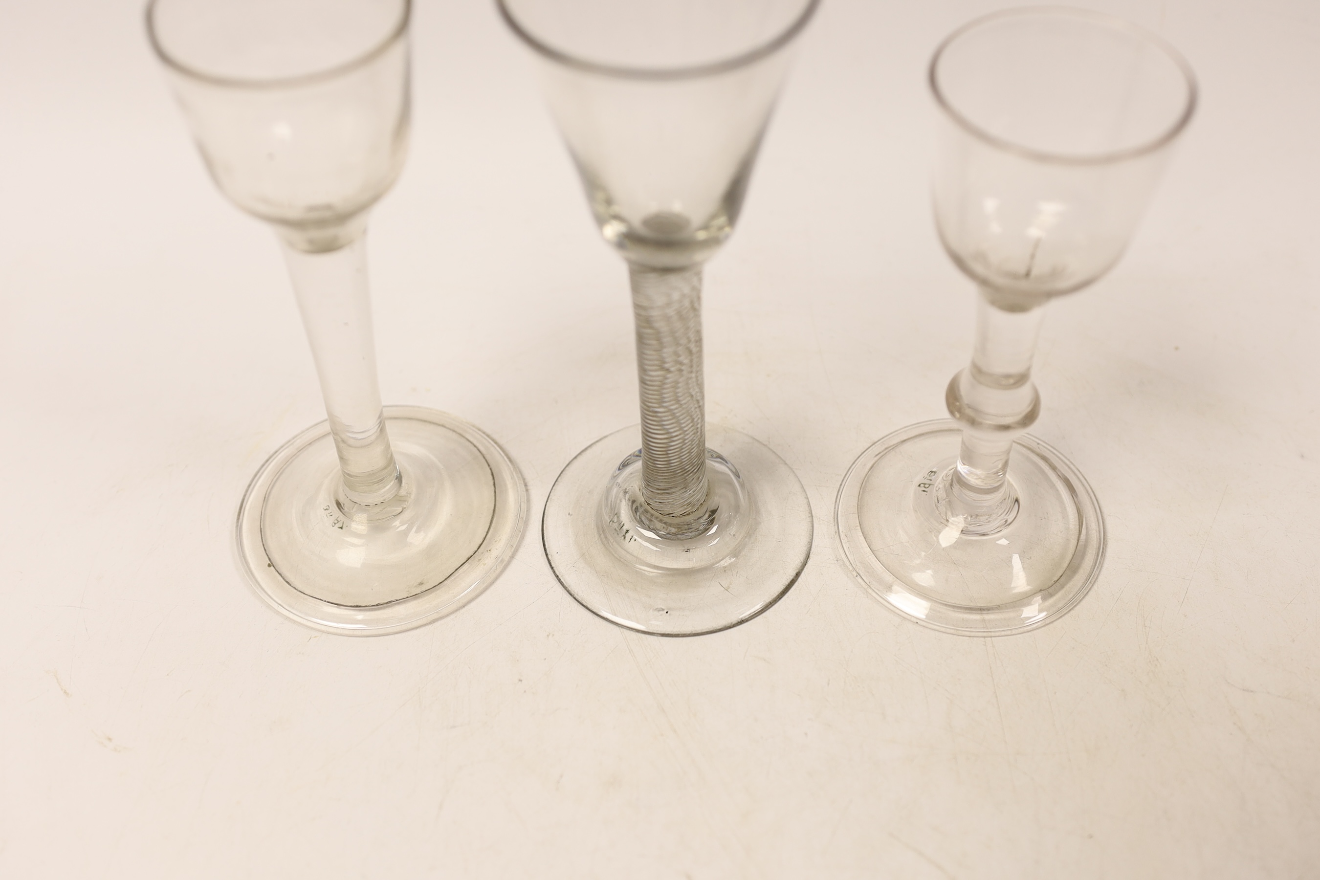 Three cordial glasses, first half 18th century, two with a folded foot, one with single knop and one with an incised twist stem, tallest 16cm